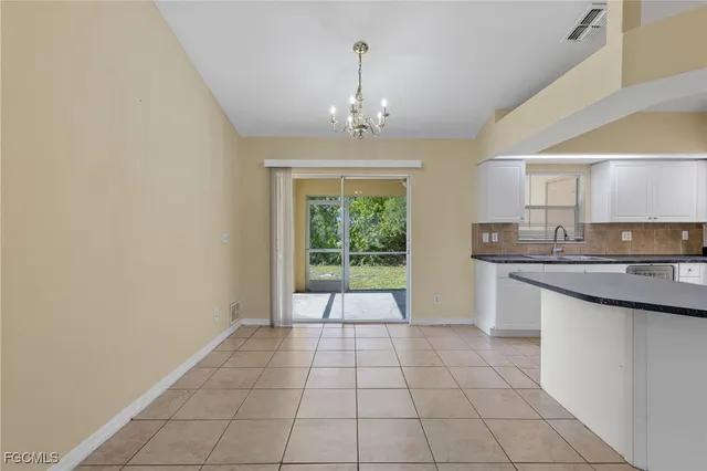 a view of an empty room with a kitchen