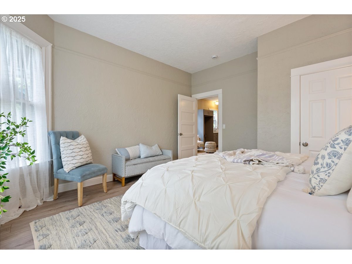 2115 Northwest 22nd Avenue Portland, OR 97210 - Photo 18 of 47 a bed room with a bed and a chair