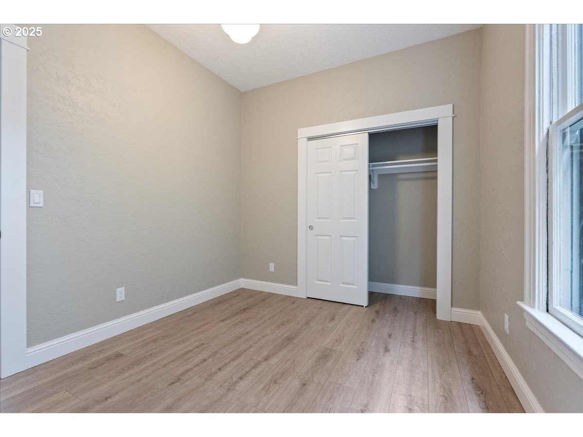 2115 Northwest 22nd Avenue Portland, OR 97210 - Photo 20 of 47 a view of an empty room with wooden floor & closet