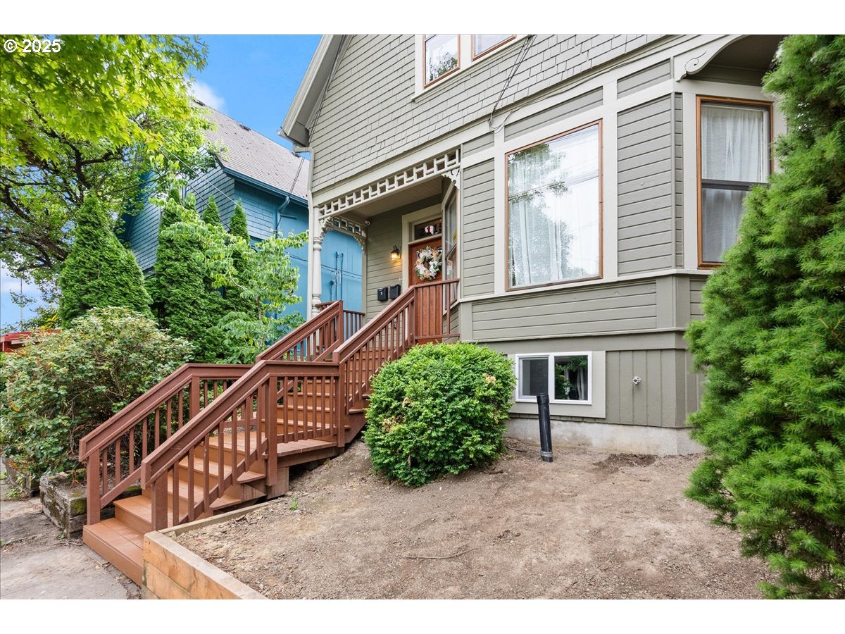 2115 Northwest 22nd Avenue Portland, OR 97210 - Photo 2 of 47 a view of a house with brick walls and a plants with wooden fence