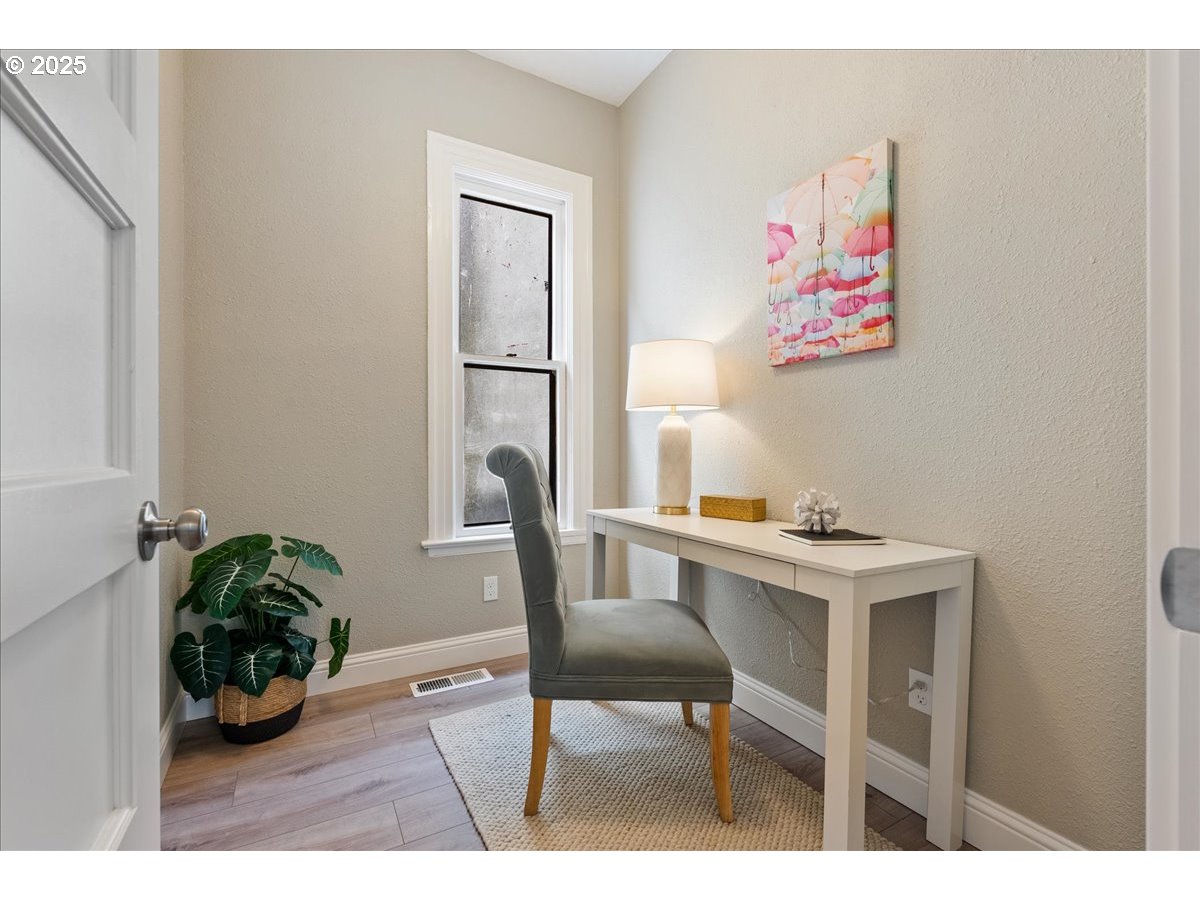 2115 Northwest 22nd Avenue Portland, OR 97210 - Photo 22 of 47 a view of a workspace with furniture and a potted plant