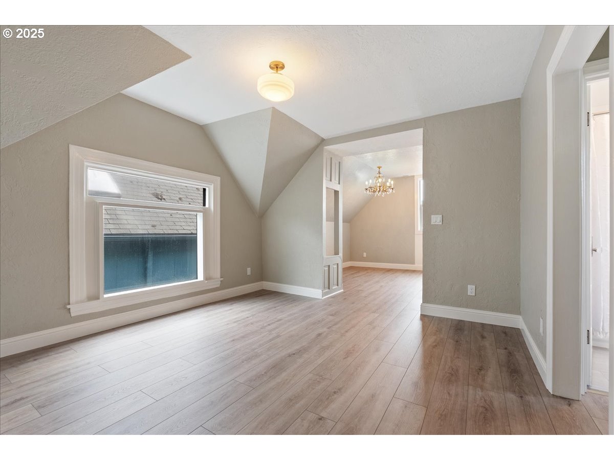 2115 Northwest 22nd Avenue Portland, OR 97210 - Photo 26 of 47 a view of an empty room with wooden floor and a window
