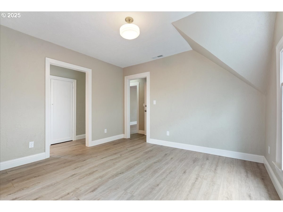 2115 Northwest 22nd Avenue Portland, OR 97210 - Photo 27 of 47 a view of an empty room with wooden floor