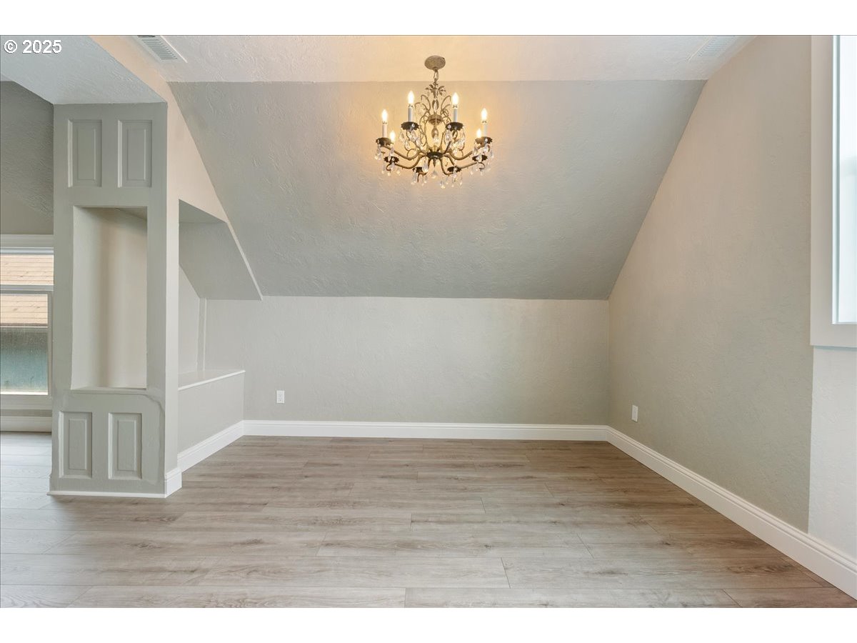 2115 Northwest 22nd Avenue Portland, OR 97210 - Photo 29 of 47 a view of an empty room with wooden floor and a window