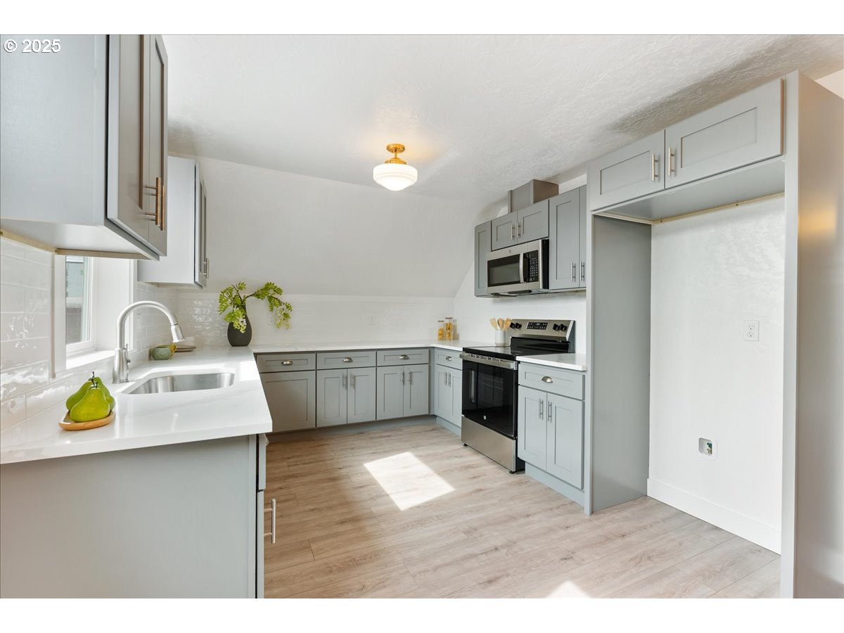 2115 Northwest 22nd Avenue Portland, OR 97210 - Photo 31 of 47 a kitchen with a sink appliances and cabinets