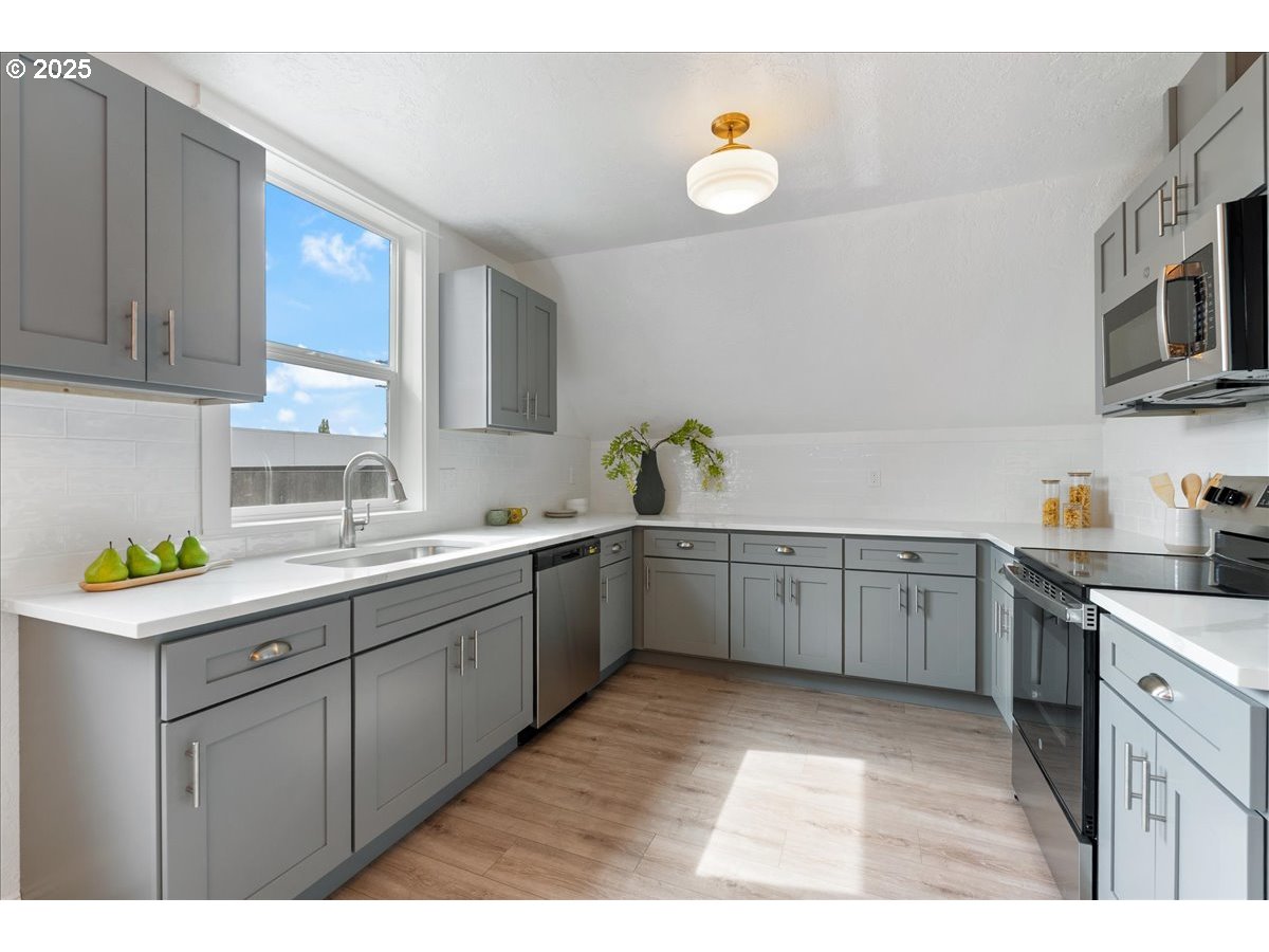 2115 Northwest 22nd Avenue Portland, OR 97210 - Photo 32 of 47 a kitchen with a sink window and cabinets