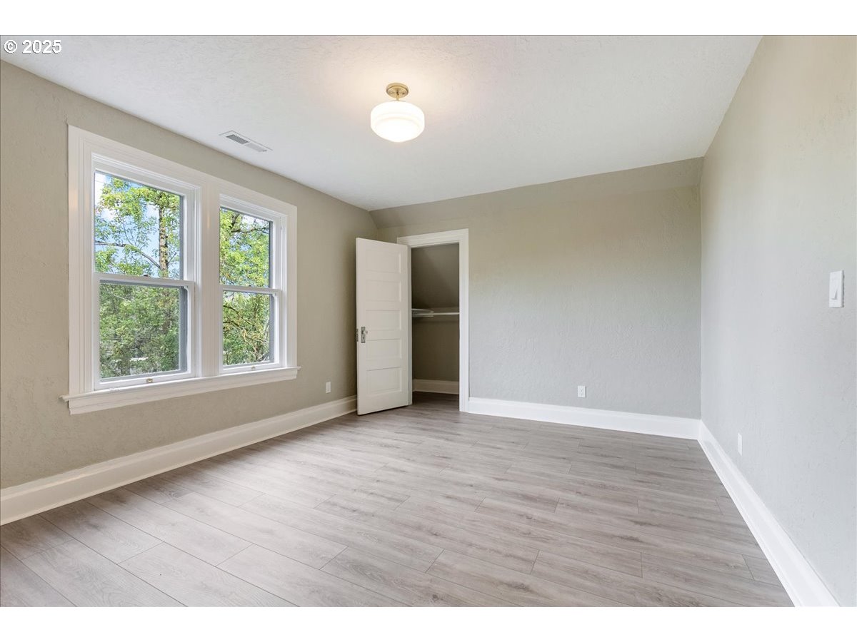 2115 Northwest 22nd Avenue Portland, OR 97210 - Photo 37 of 47 a view of an empty room with wooden floor and a window