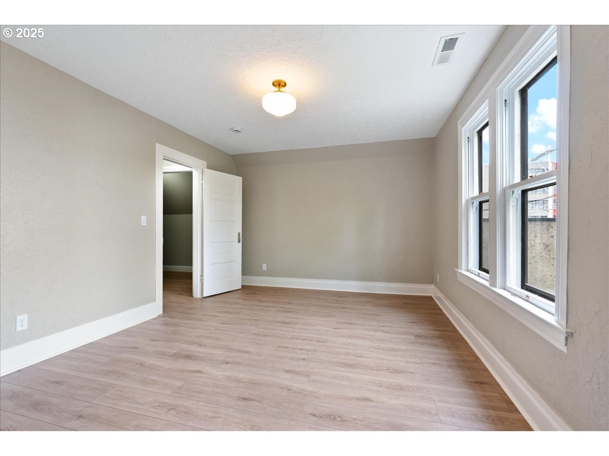 2115 Northwest 22nd Avenue Portland, OR 97210 - Photo 38 of 47 a view of an empty room with wooden floor and a window