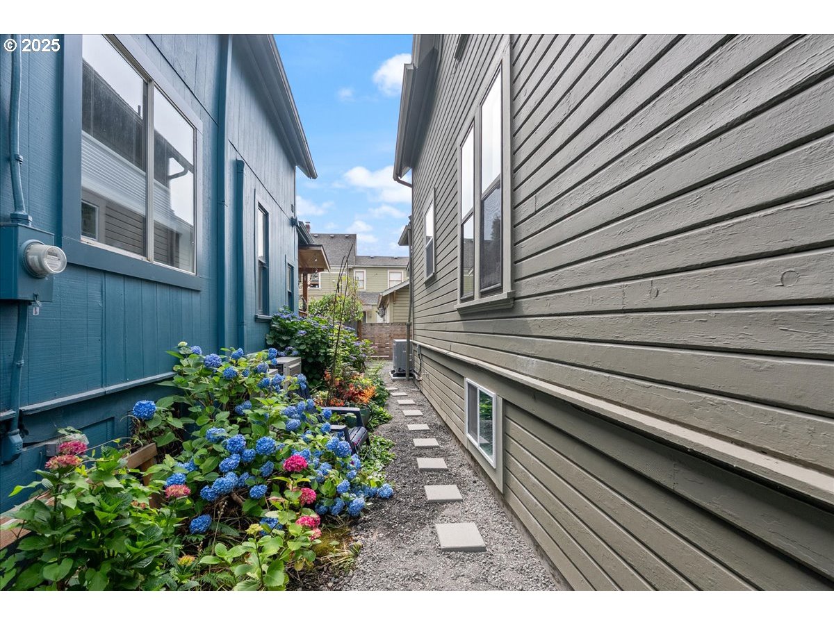 2115 Northwest 22nd Avenue Portland, OR 97210 - Photo 41 of 47 a view of a house with a flower garden