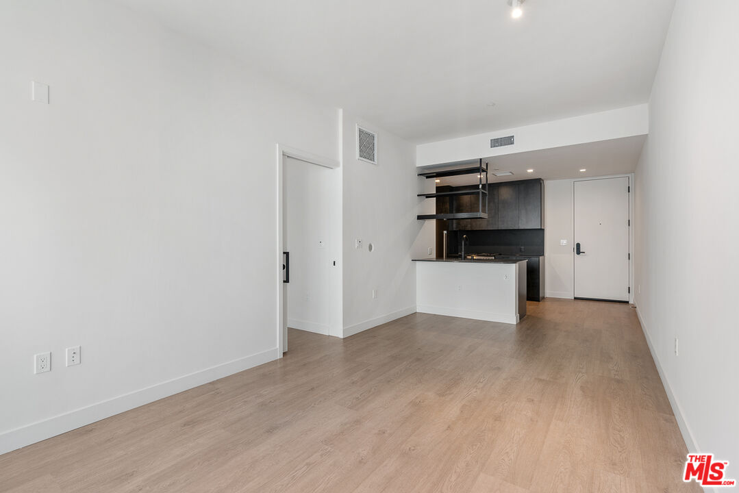 10700 Tabor Street, Unit 511 Los Angeles, CA 90034 - Photo 7 of 26 a view of a kitchen with a sink and refrigerator