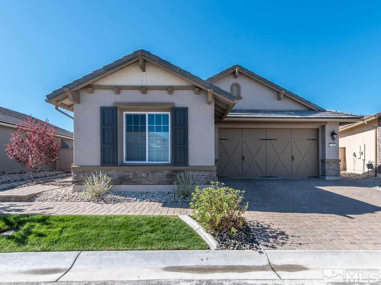 2180 Arpagos Lane Reno, NV 89521 - Photo 1 of 25 a front view of a house with a yard and garage