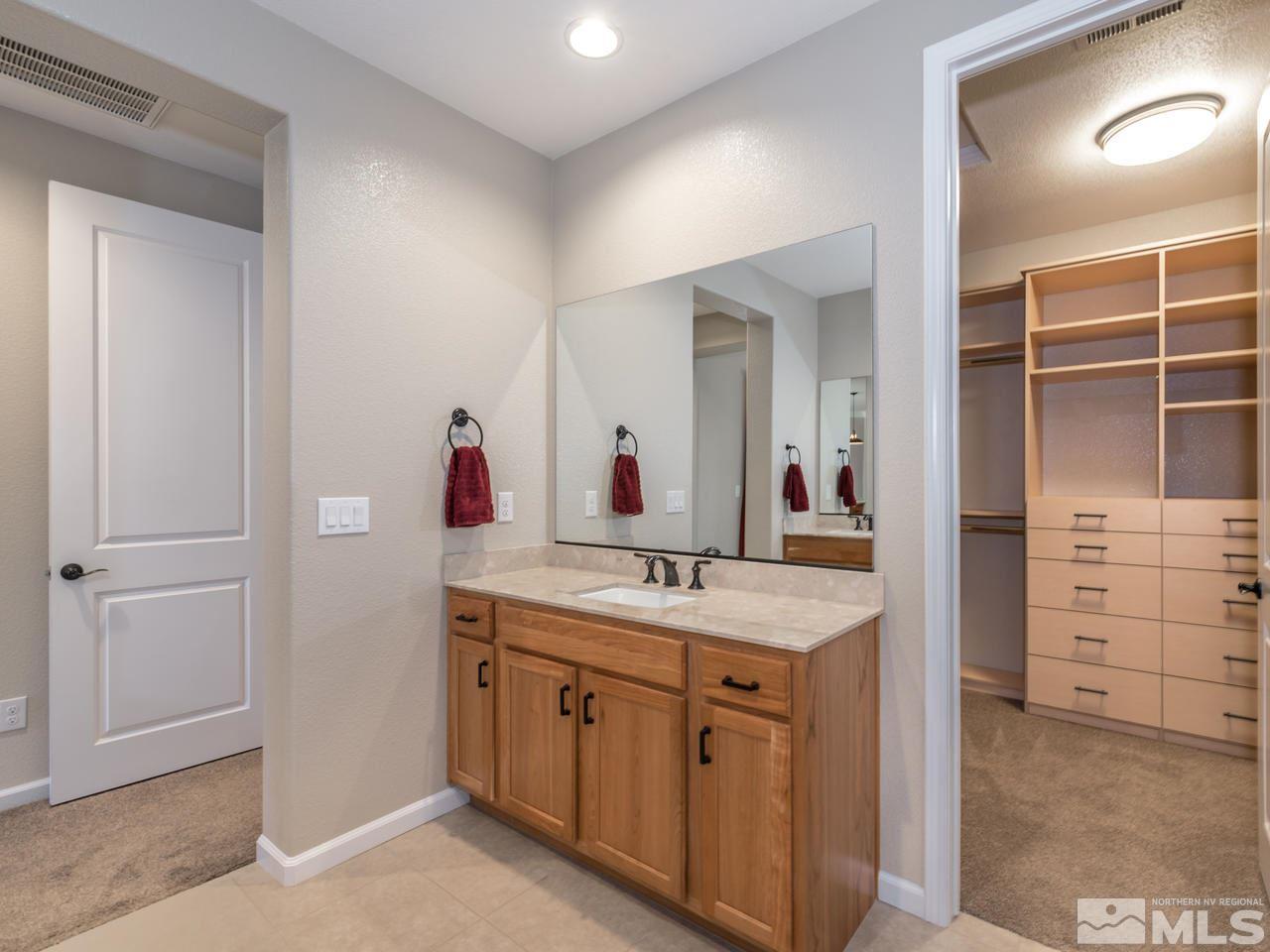 2180 Arpagos Lane Reno, NV 89521 - Photo 16 of 25 a bathroom with a sink and a mirror