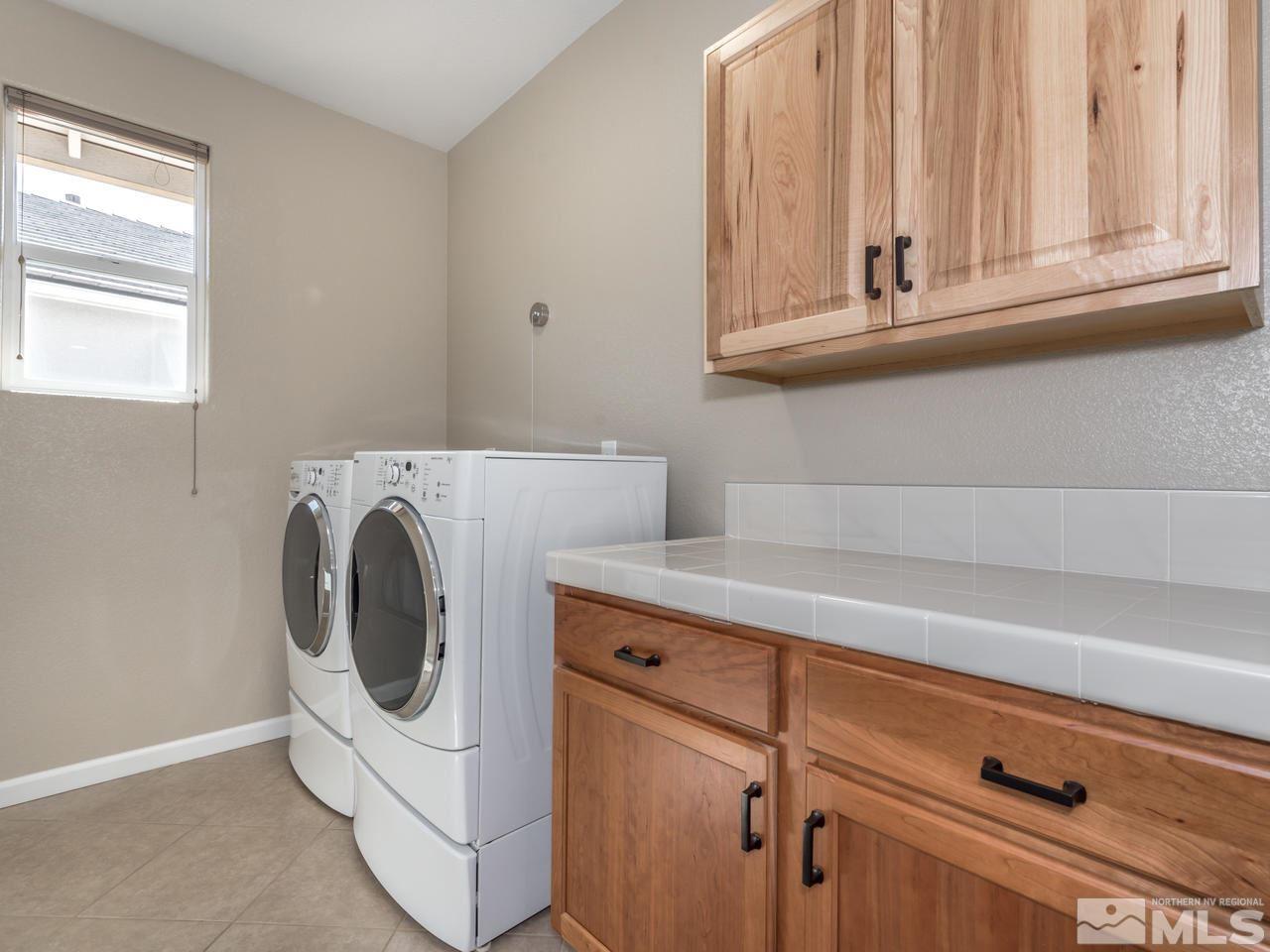 2180 Arpagos Lane Reno, NV 89521 - Photo 20 of 25 a utility room with dryer and washer