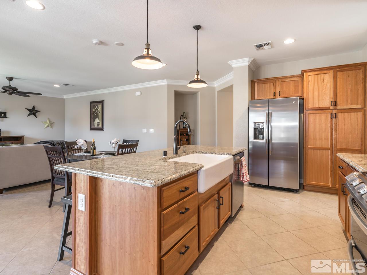 2180 Arpagos Lane Reno, NV 89521 - Photo 7 of 25 a kitchen with stainless steel appliances granite countertop a sink a stove a refrigerator and island