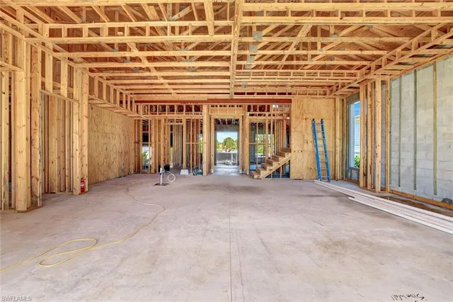 a view of a room with floor to ceiling windows and wooden walls