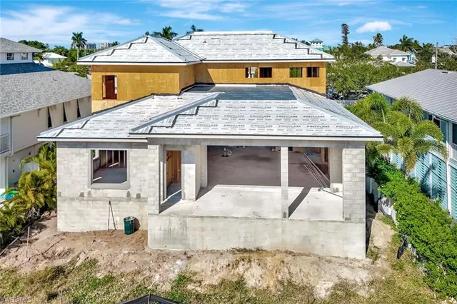an aerial view of residential houses with outdoor space and lakeside