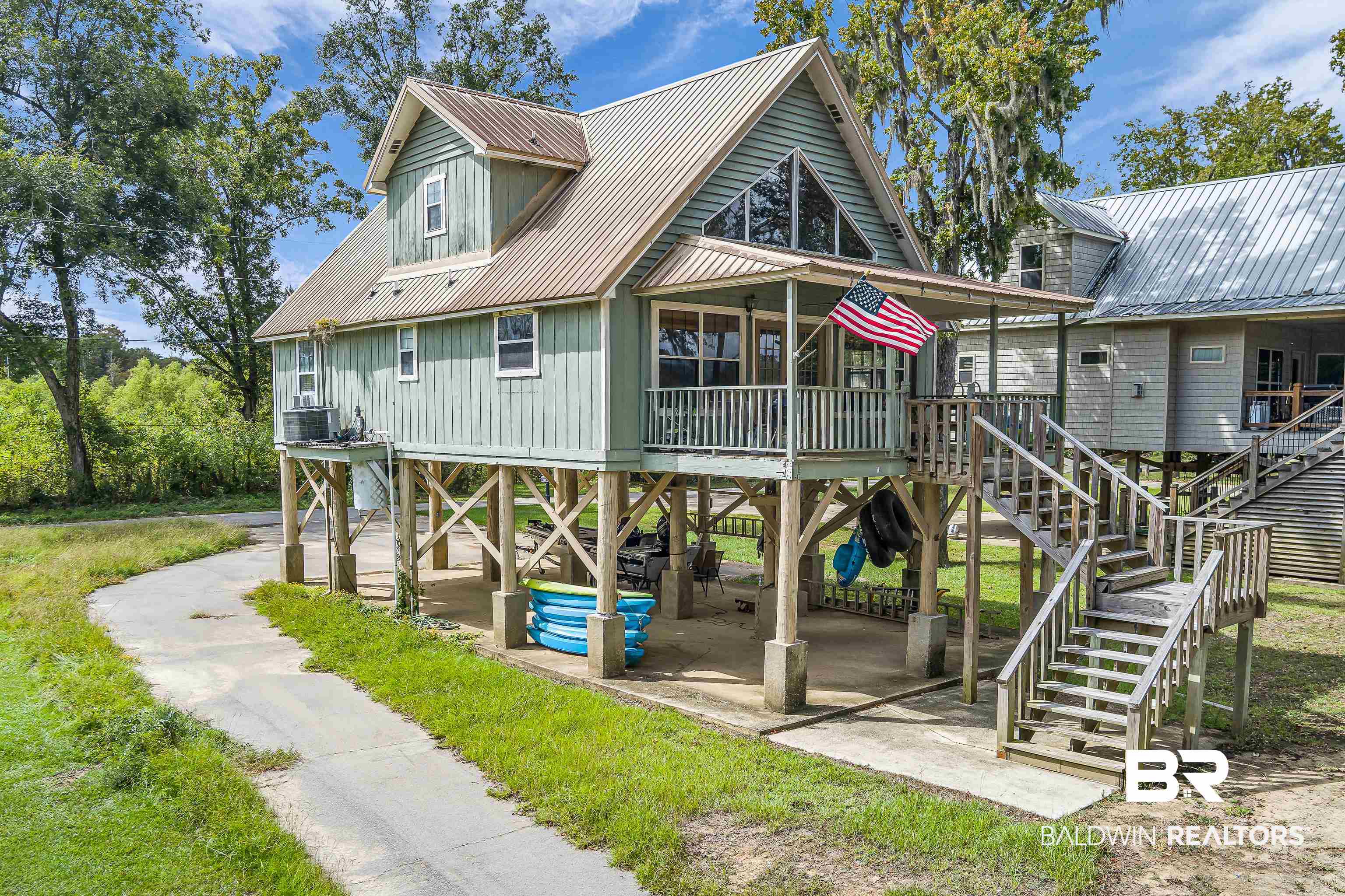 8317 Bryant's Lndg Road Stockton, AL 36579 - Photo 25 of 28 View of front of house featuring a metal roof and stairs
