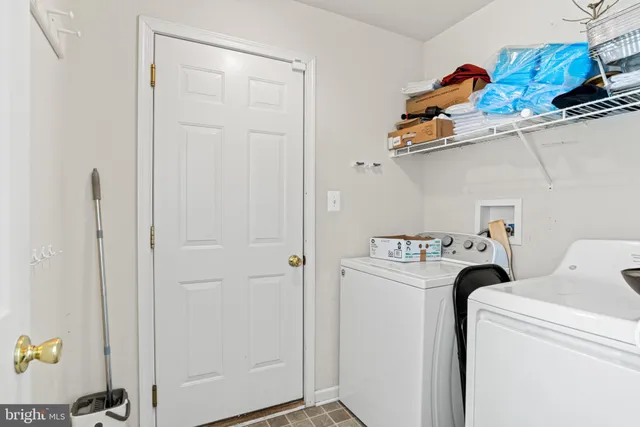 a view of a hallway with wooden floor and entryway