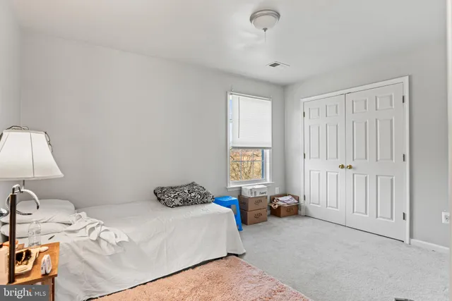 a bedroom with a bed and a lamp