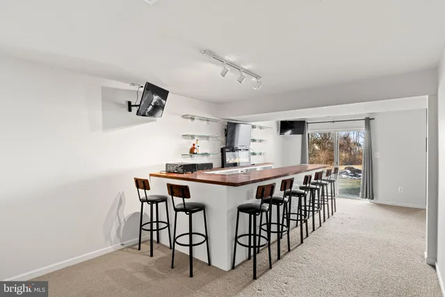 a view of an empty room with window and cabinet