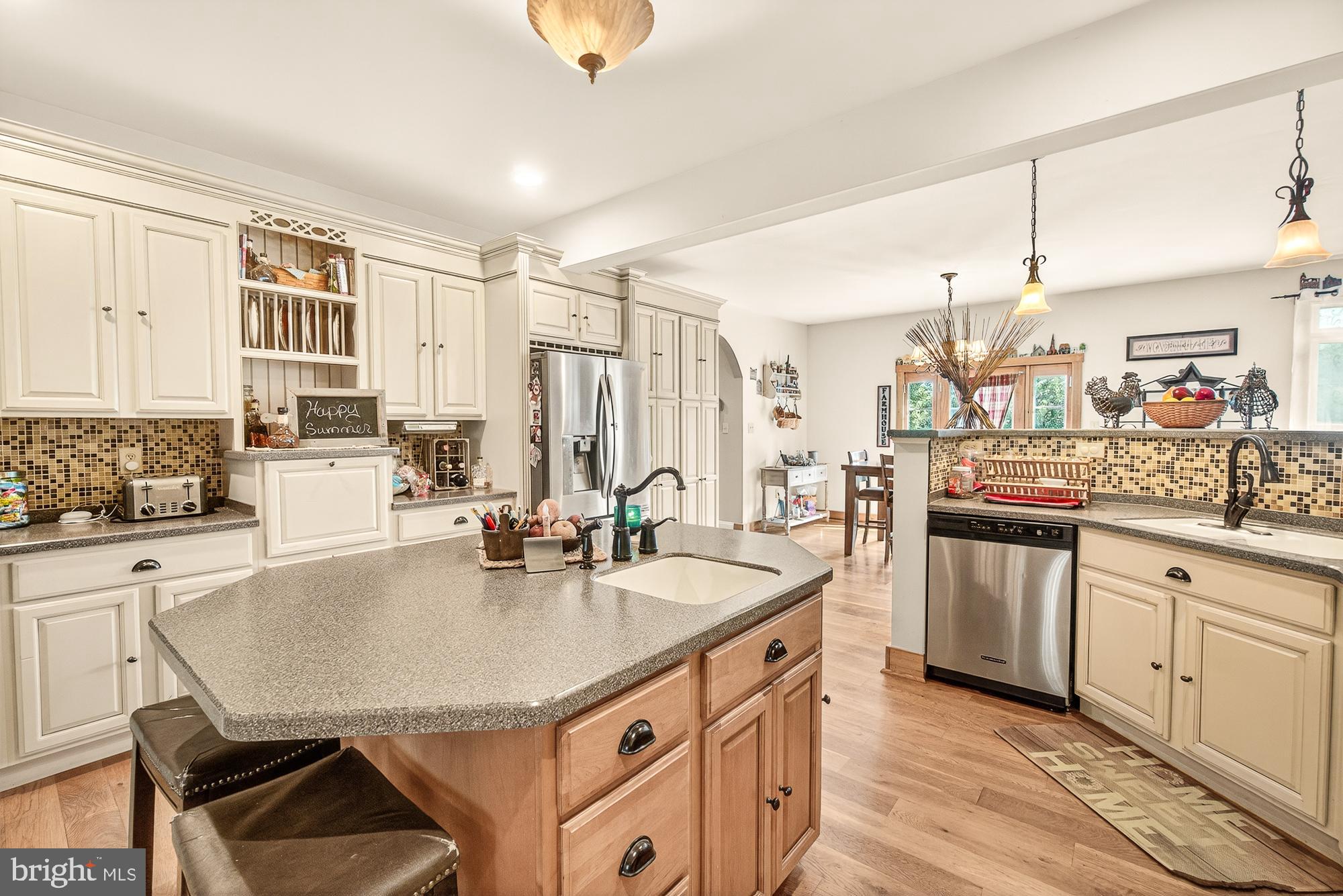 4948 Teen Barnes Road Frederick, MD 21703 - Photo 18 of 56 a kitchen with stainless steel appliances granite countertop a sink a stove and chairs