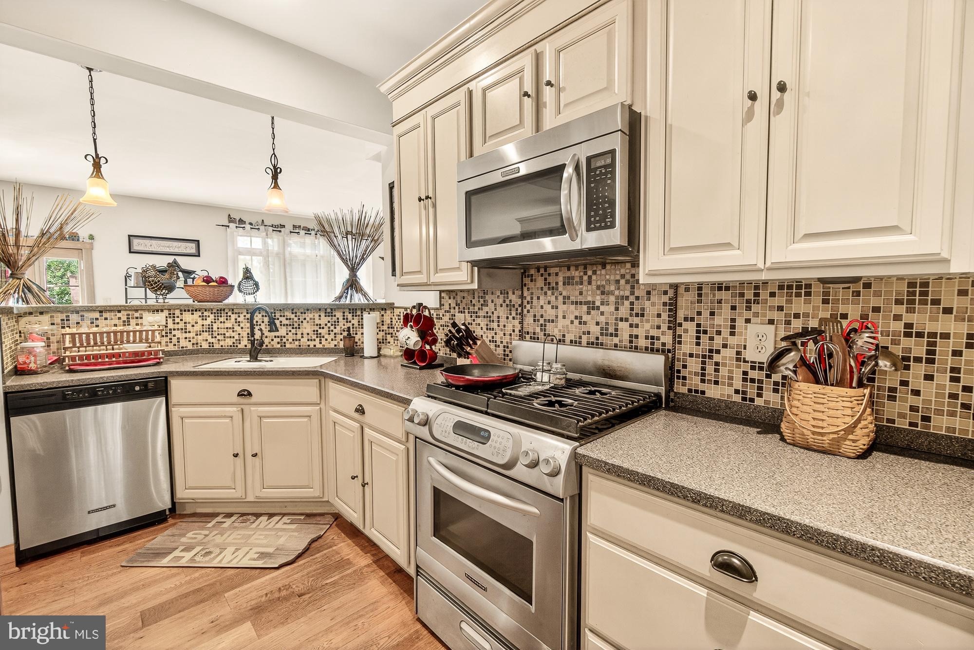 4948 Teen Barnes Road Frederick, MD 21703 - Photo 19 of 56 a kitchen with stainless steel appliances granite countertop a sink stove and microwave