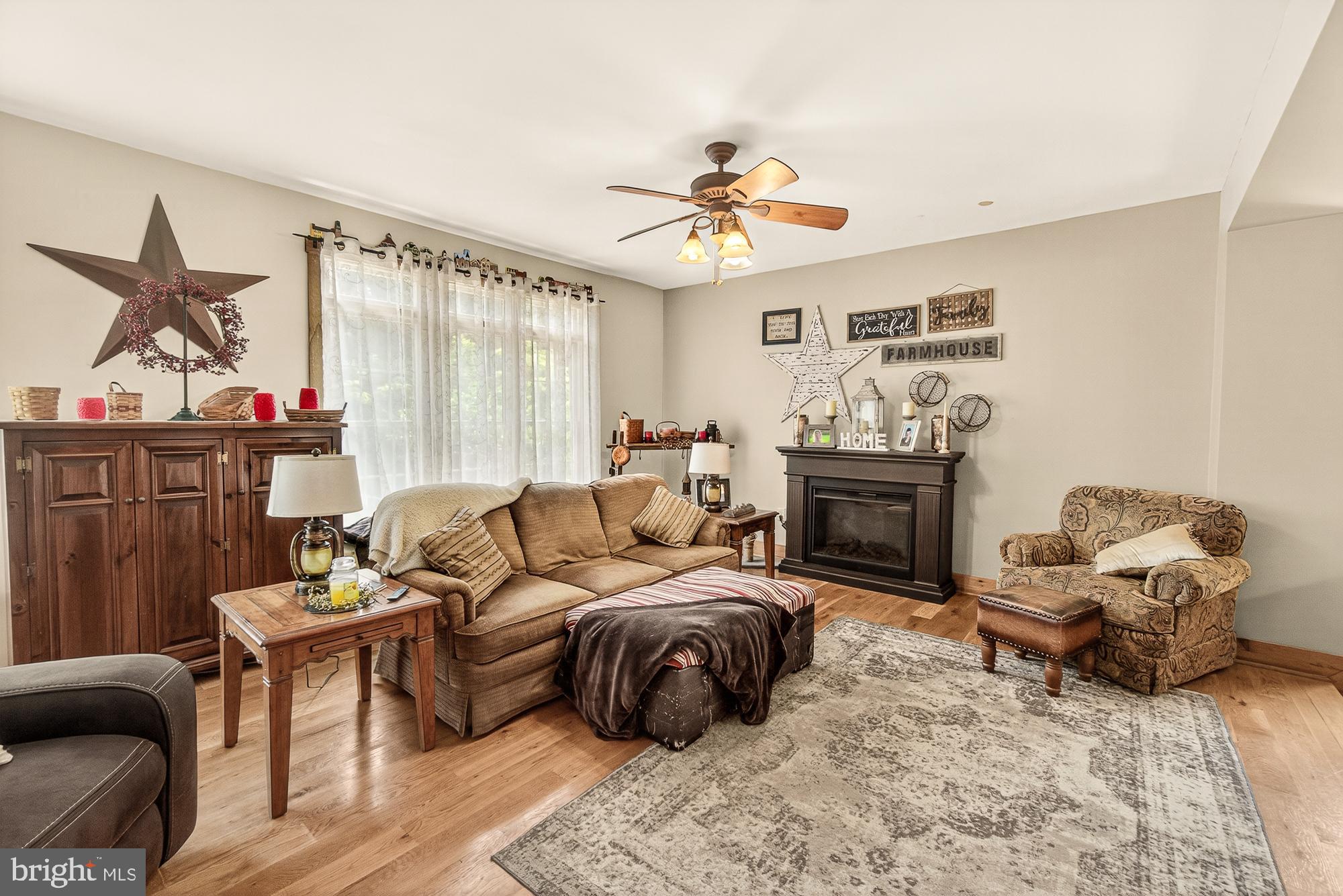 4948 Teen Barnes Road Frederick, MD 21703 - Photo 25 of 56 a living room with furniture a fireplace and a chandelier