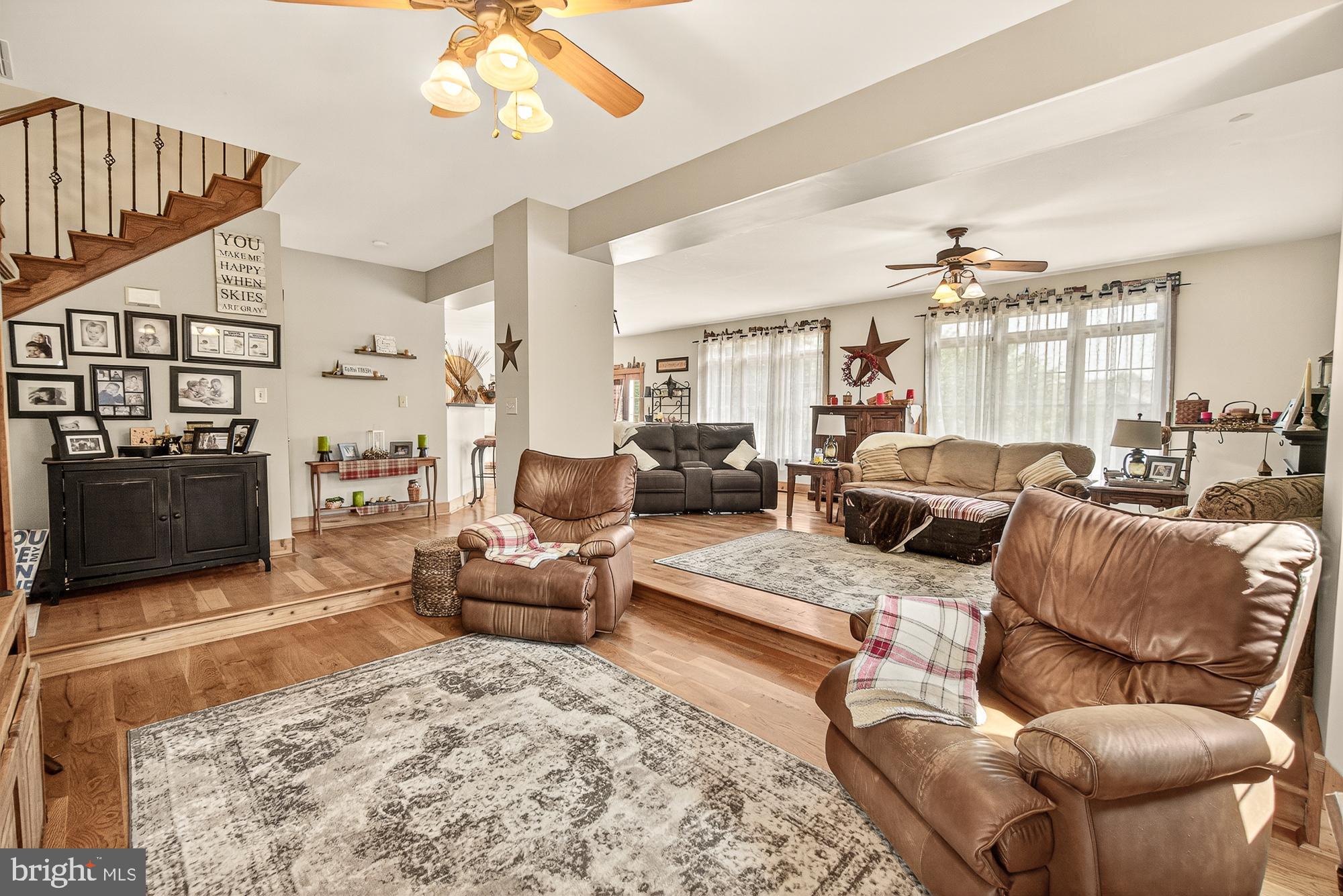 4948 Teen Barnes Road Frederick, MD 21703 - Photo 27 of 56 a living room with furniture a chandelier and a flat screen tv