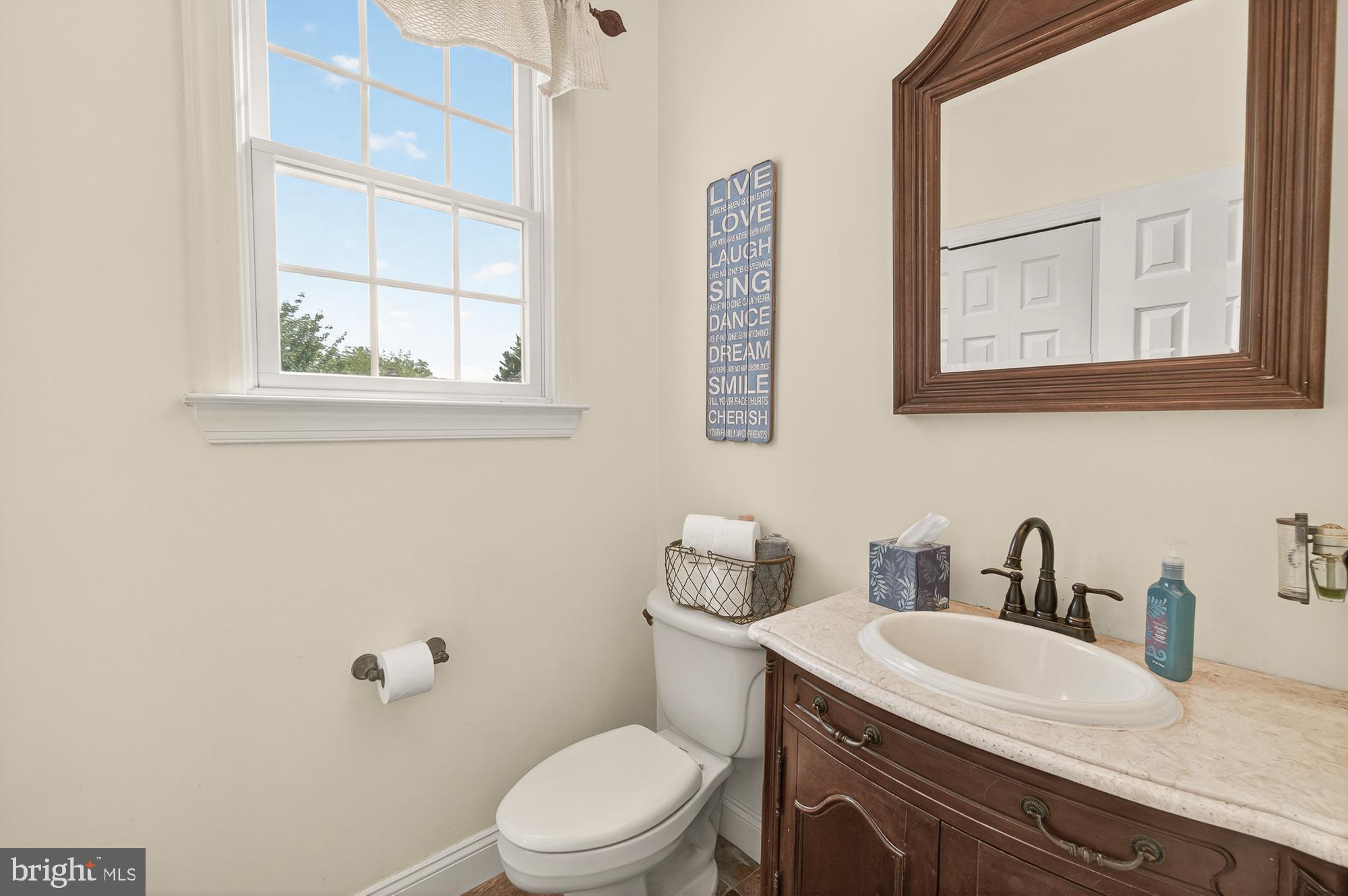 4948 Teen Barnes Road Frederick, MD 21703 - Photo 29 of 56 a bathroom with a toilet a sink and mirror