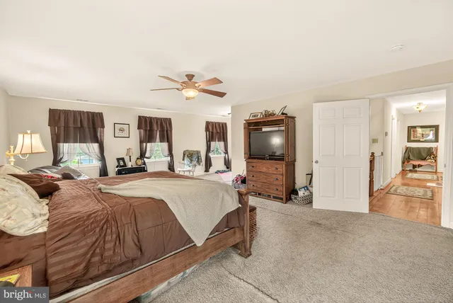 a bathroom with a tub a sink and a mirror