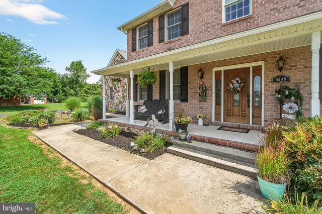 front view of a brick house with a yard