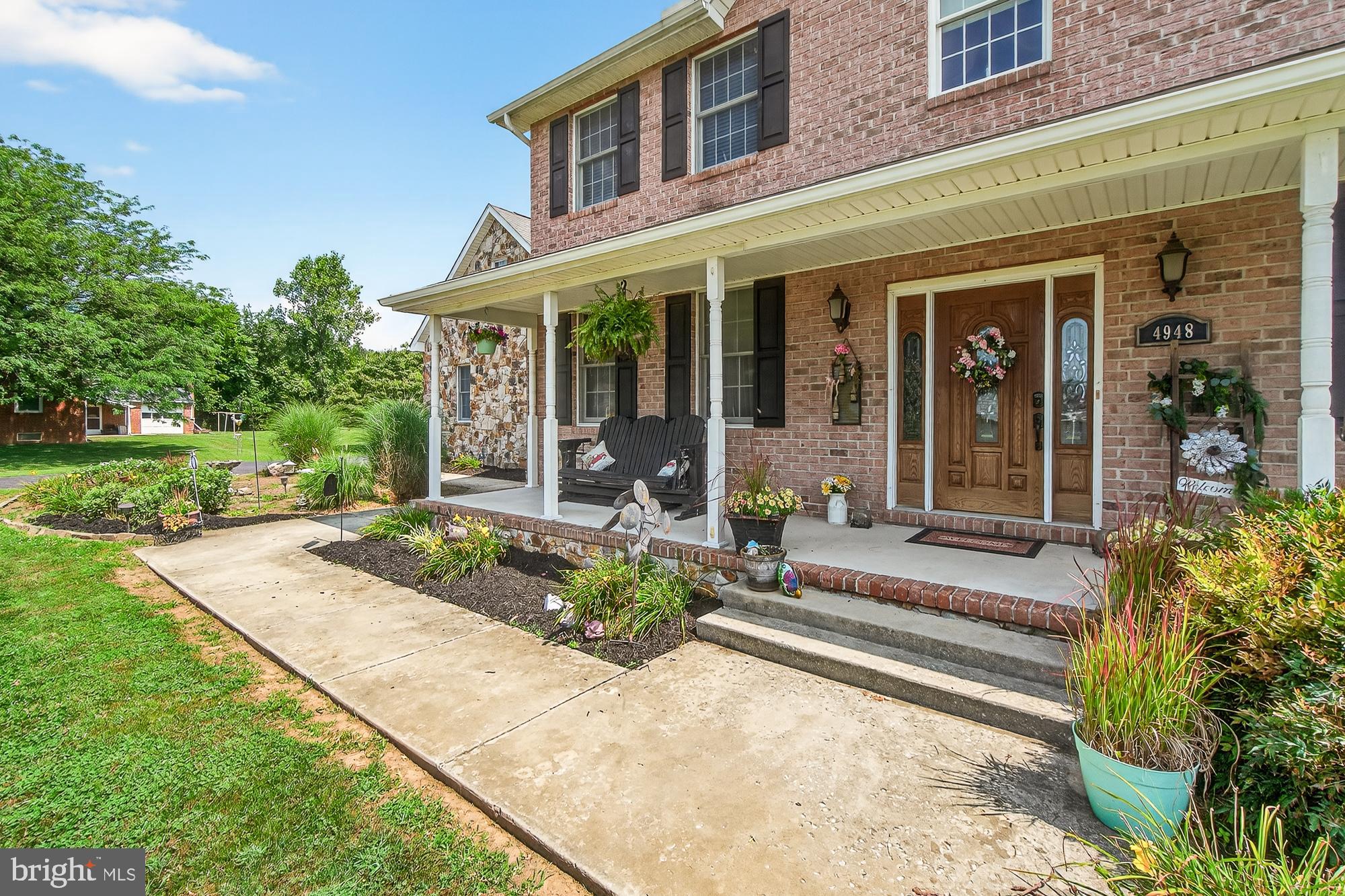 4948 Teen Barnes Road Frederick, MD 21703 - Photo 4 of 56 front view of a brick house with a yard