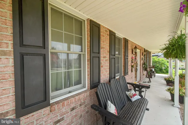 a living room with furniture a flat screen tv and a window