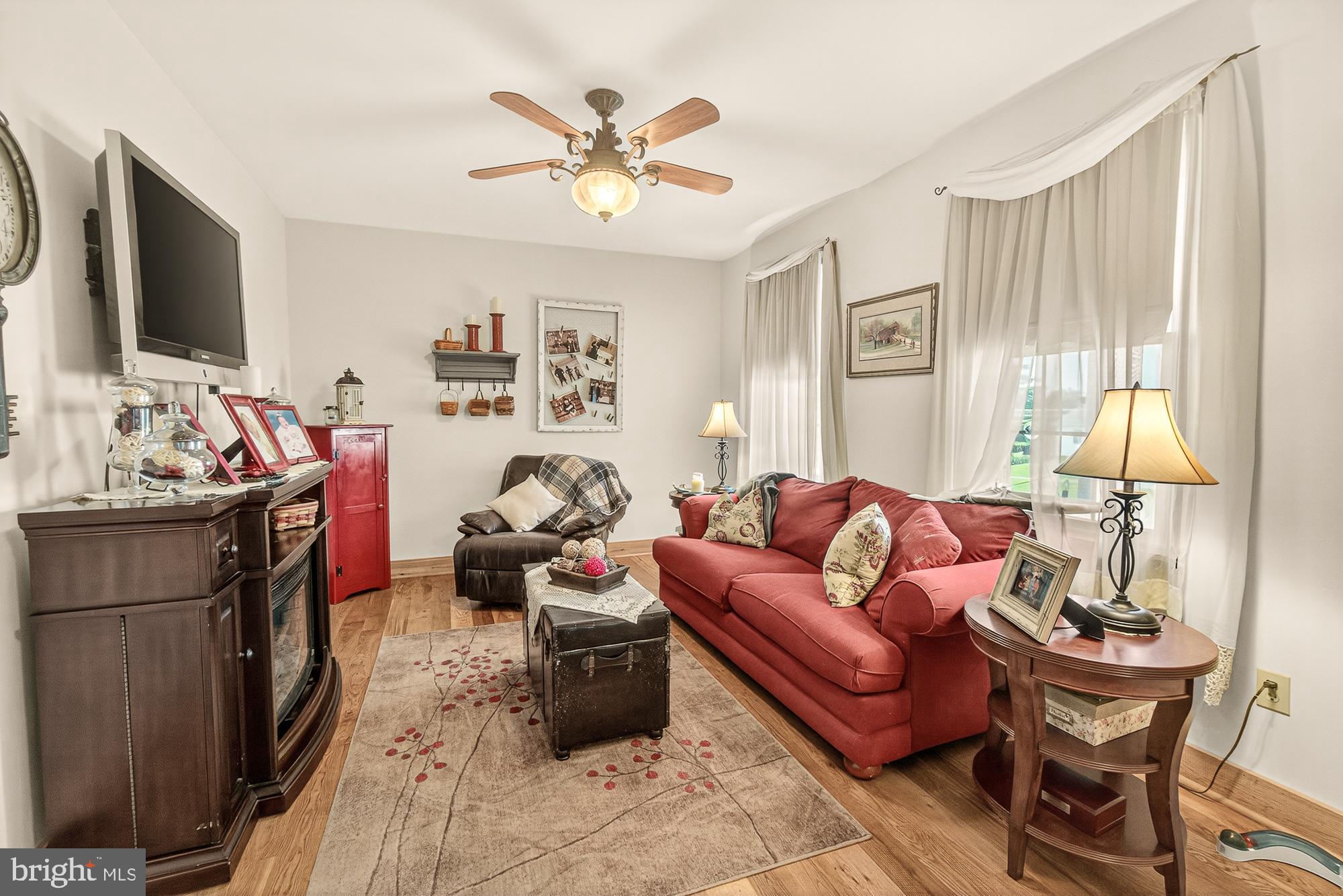 4948 Teen Barnes Road Frederick, MD 21703 - Photo 8 of 56 a living room with furniture a flat screen tv and a window