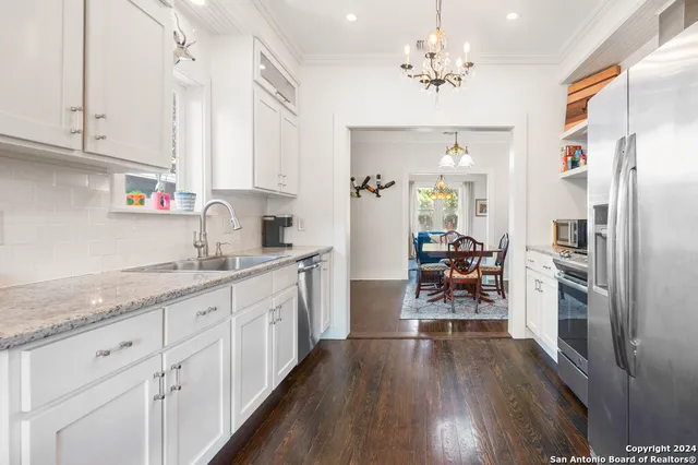 a kitchen with sink cabinets and stainless steel appliances