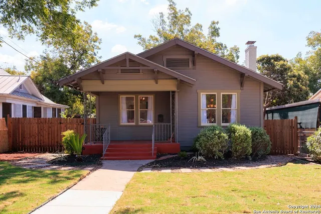 a front view of a house with a yard outdoor seating and garage