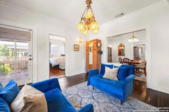 a living room with furniture and a chandelier