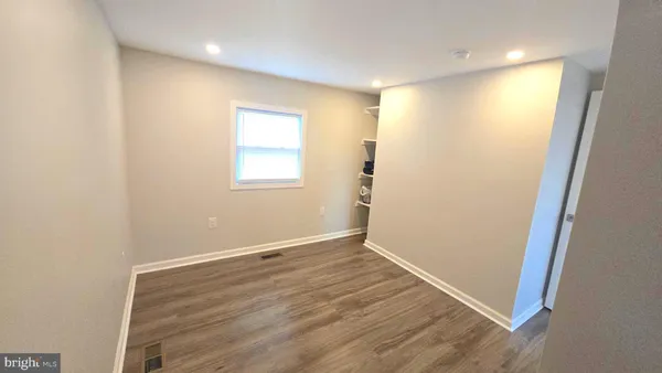a view of a room with wooden floor