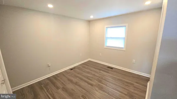 a view of entryway with furniture and wooden floor