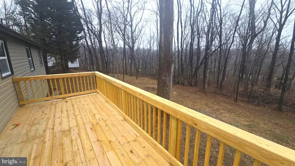 a view of balcony with wooden floor and fence