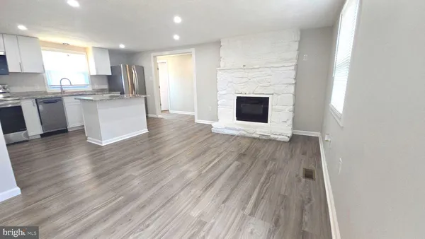a view of kitchen with cabinets and wooden floor