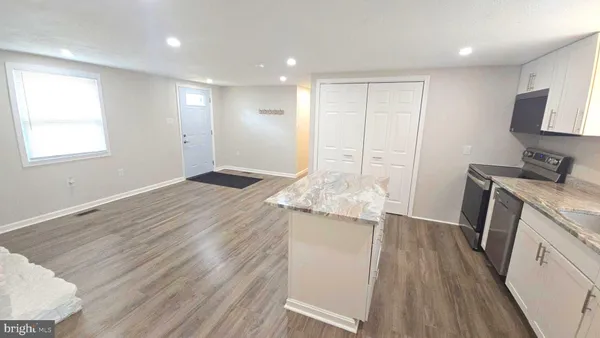 a kitchen with a refrigerator sink and cabinets