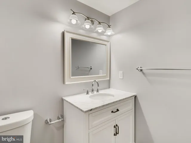 a bathroom with a sink vanity and a mirror
