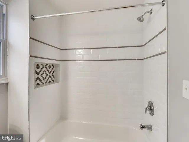a bathroom with a shower and a bath tub
