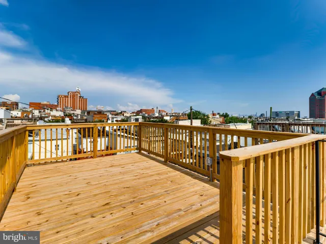 a view of roof deck with two chairs and wooden floor