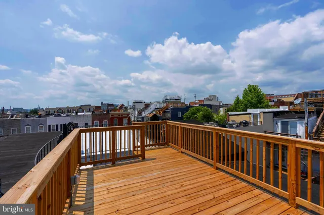 a view of a balcony with wooden floor and city view