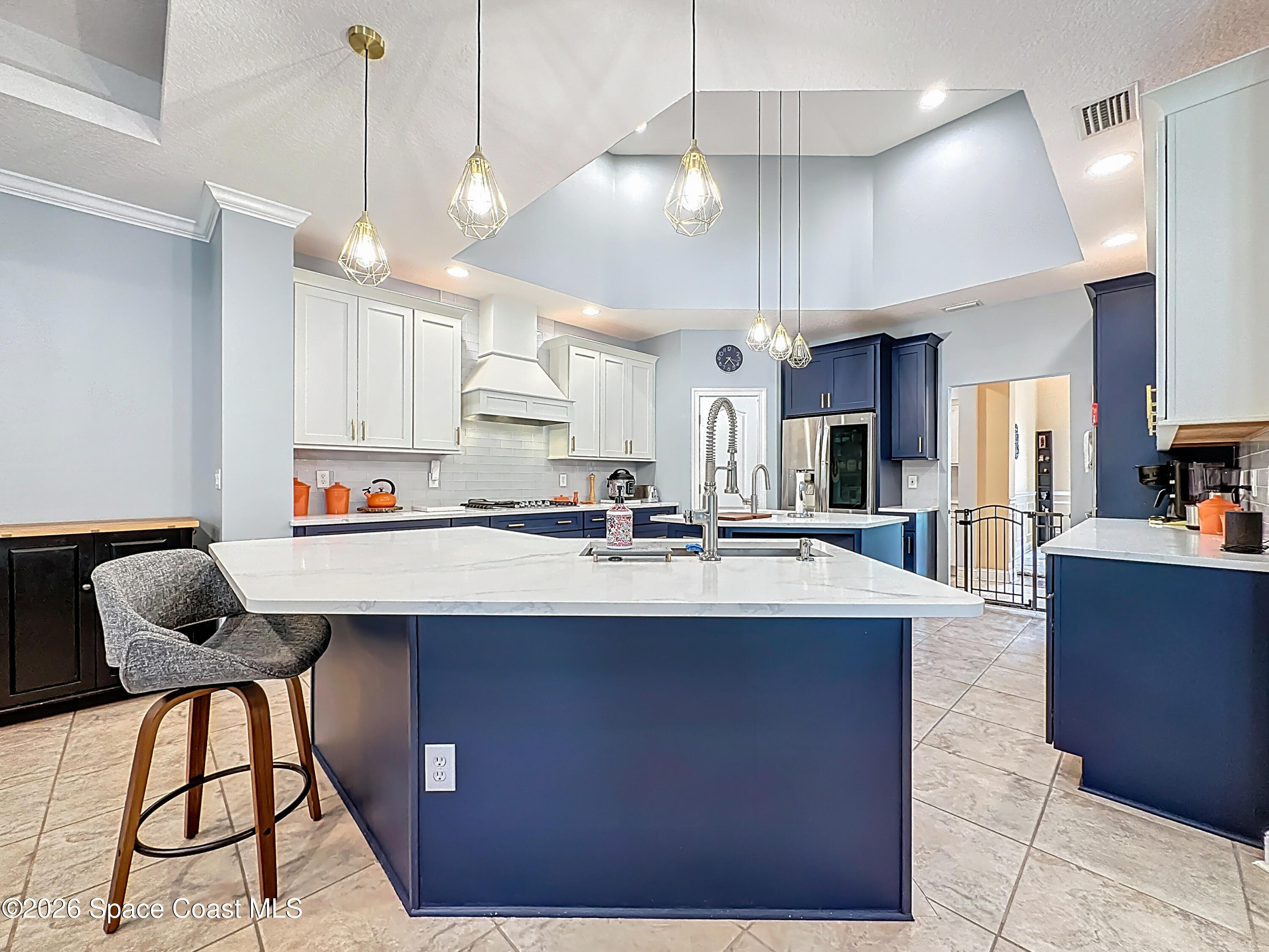 2851 Armsdale Road Jacksonville, FL 32218 - Photo 19 of 89 a kitchen with stainless steel appliances kitchen island a table chairs in it and wooden floors