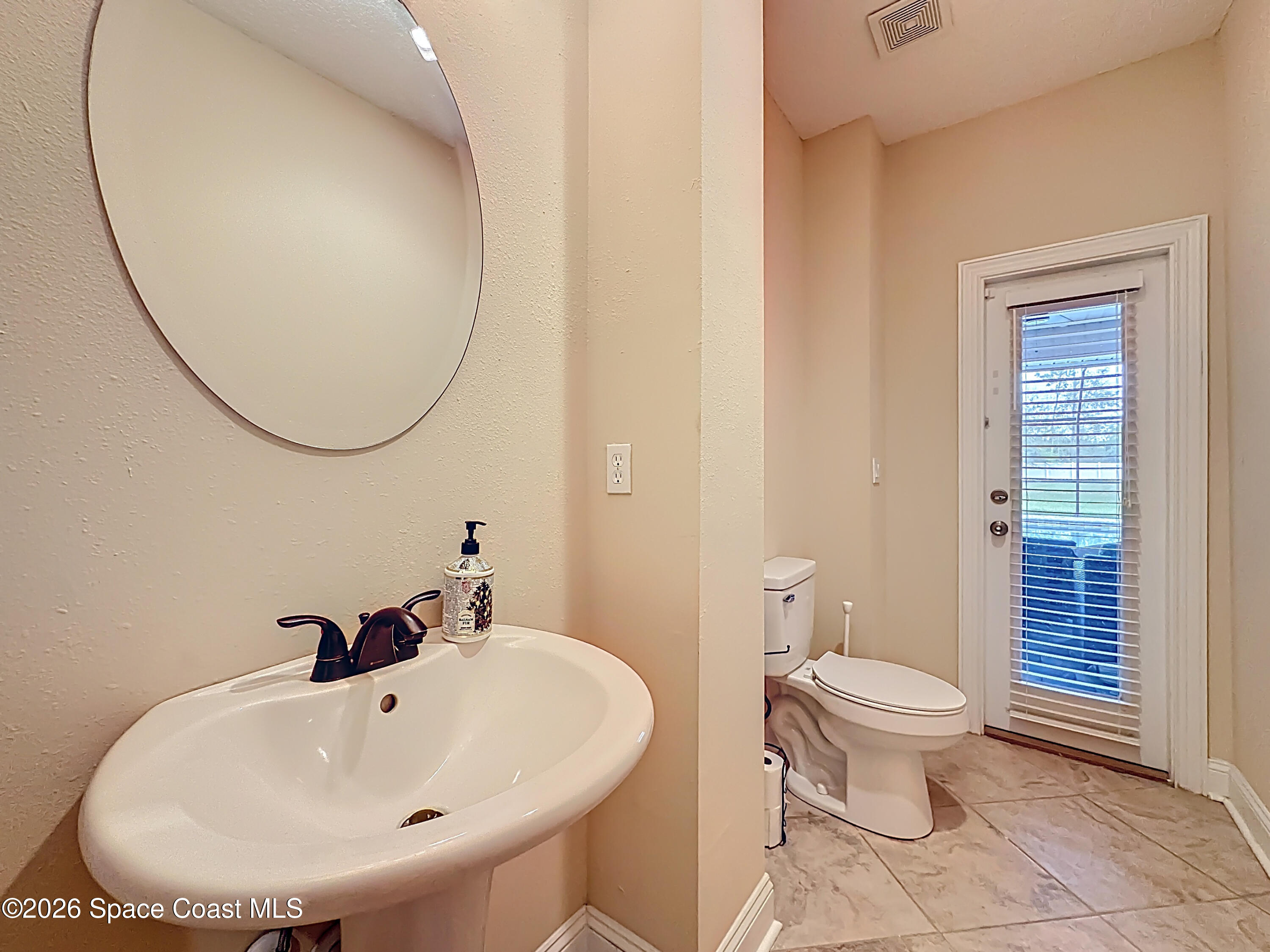 2851 Armsdale Road Jacksonville, FL 32218 - Photo 26 of 89 a bathroom with a sink and a mirror