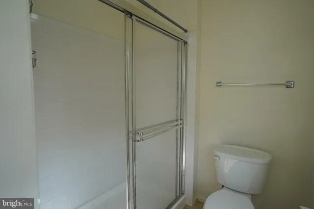 a bathroom with a toilet and a shower