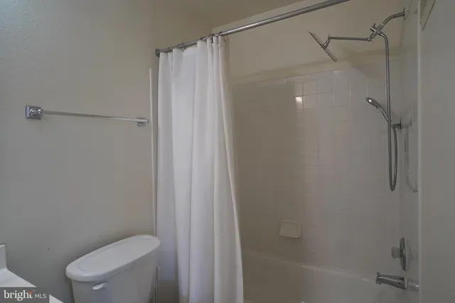a bathroom with a shower and a toilet